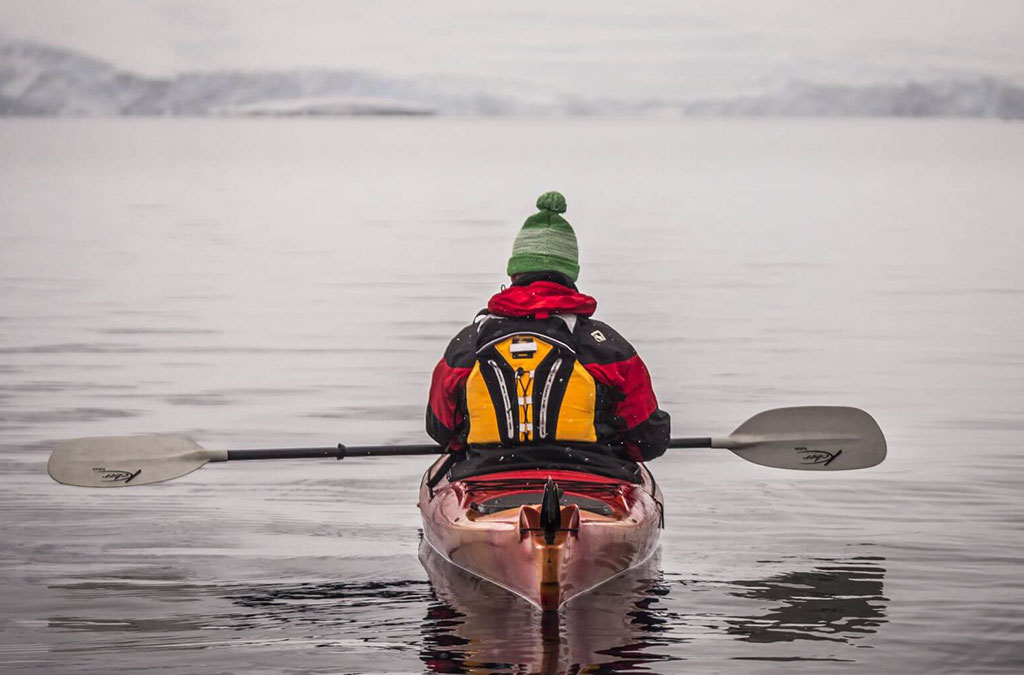 un kayakiste en antarctique dan sles eaux calmes